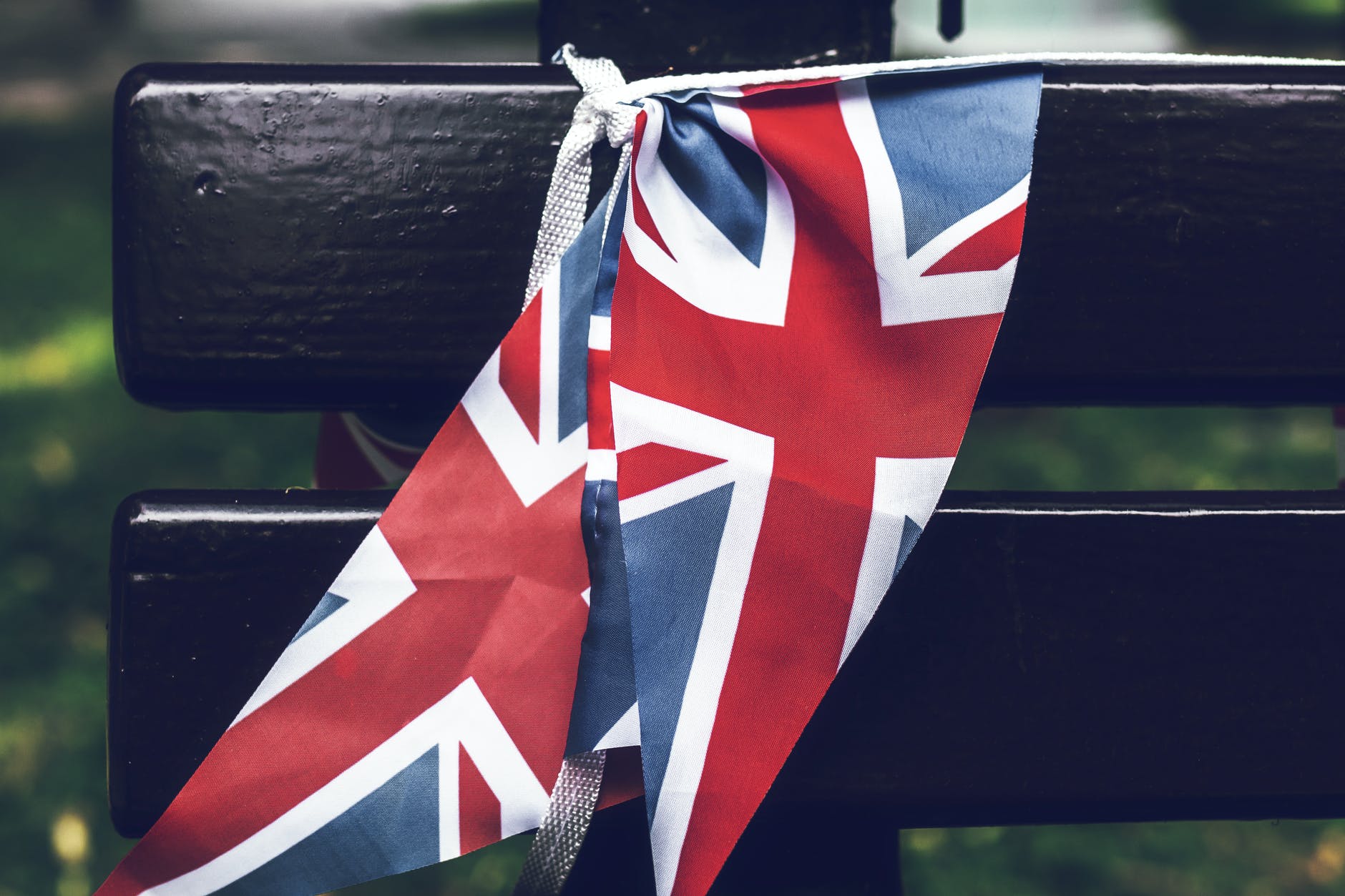 united kingdom flag tied to a wooden bench